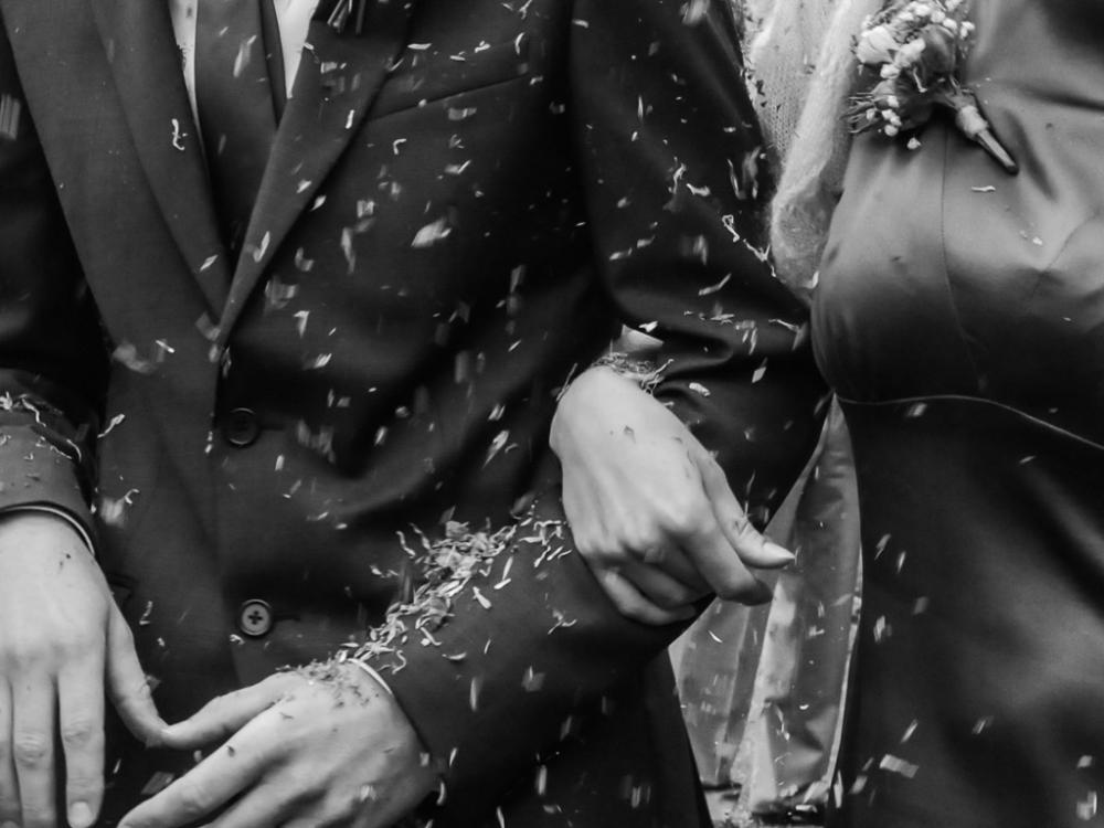 linked arms at wedding